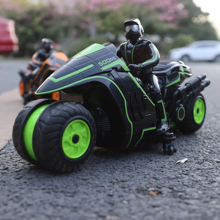 Black and green futuristic toy motorcycle with rider on outdoor pavement