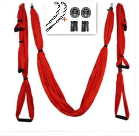 Red yoga swing set with durable fabric, adjustable straps, and metal mounting hardware.