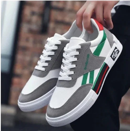 White and gray low-top sneakers with green and red accents, lace-up, casual streetwear style