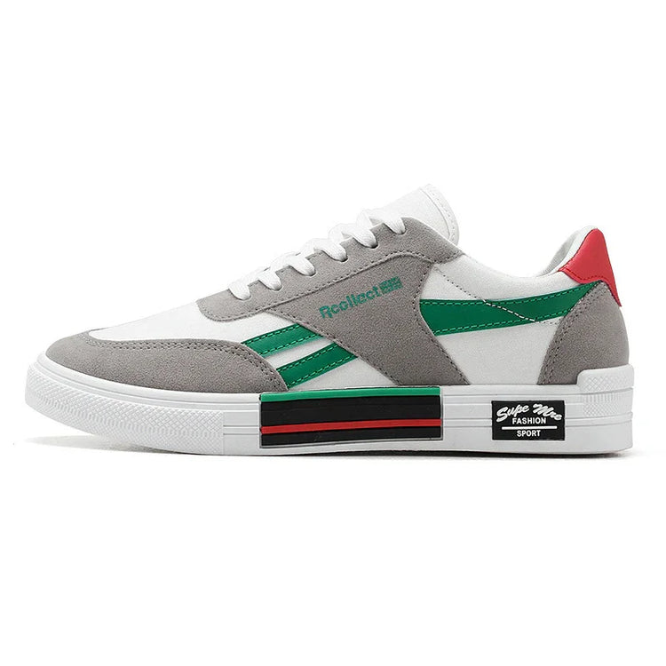 White and grey low-top sneaker with green and red accents, suede overlays, chunky sole