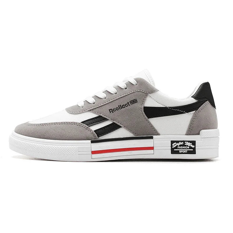 White and gray low-top sneaker with black accents, suede overlays, and a chunky sole