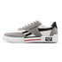 White and gray low-top sneaker with black accents, suede overlays, and a chunky sole