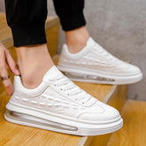 White faux leather sneakers with textured pattern and clear sole, modern streetwear style.