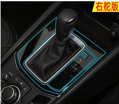 Black leather car gear shift cover with glossy black trim and illuminated blue accents