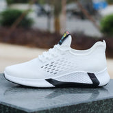 White mesh knit sneaker with black sole accents, breathable and lightweight streetwear shoe