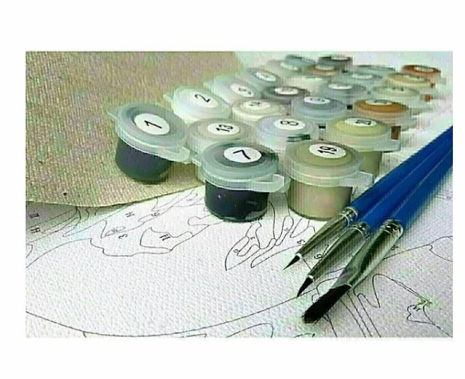 Assorted paint pots and blue paintbrushes on a numbered canvas for painting kit