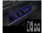 Black car door panel with illuminated blue trim and window control buttons