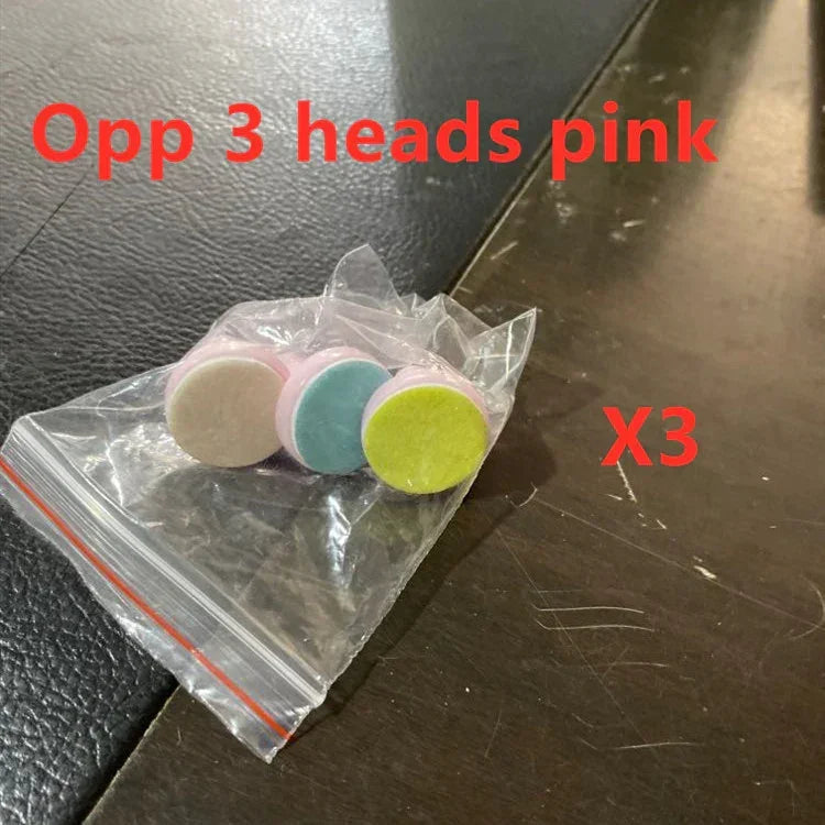 Three round pastel tablets with pink edges in a clear plastic zip bag on a table.