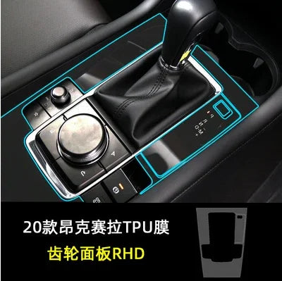 Black leather car gear shift with metallic control dial and glossy panel, TPU cover outlined in blue.