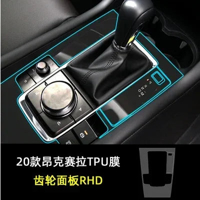 Black leather car gear shift with metallic control dial and glossy panel, TPU cover outlined in blue.
