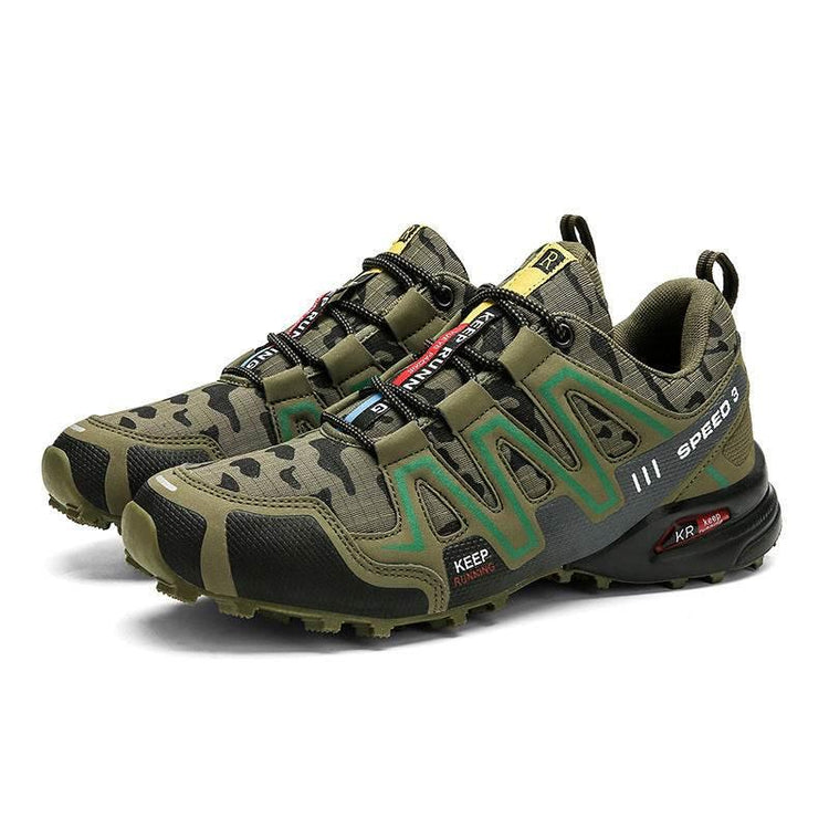 Camouflage-patterned, green and black athletic sneakers with rugged sole and mesh material.