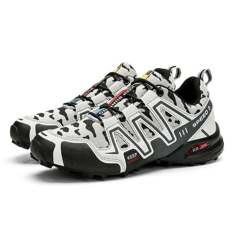 White and black camo trail sneakers with mesh upper, rugged sole, and low-cut fit.