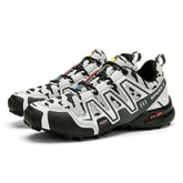 White and black camo trail sneakers with mesh upper, rugged sole, and low-cut fit.