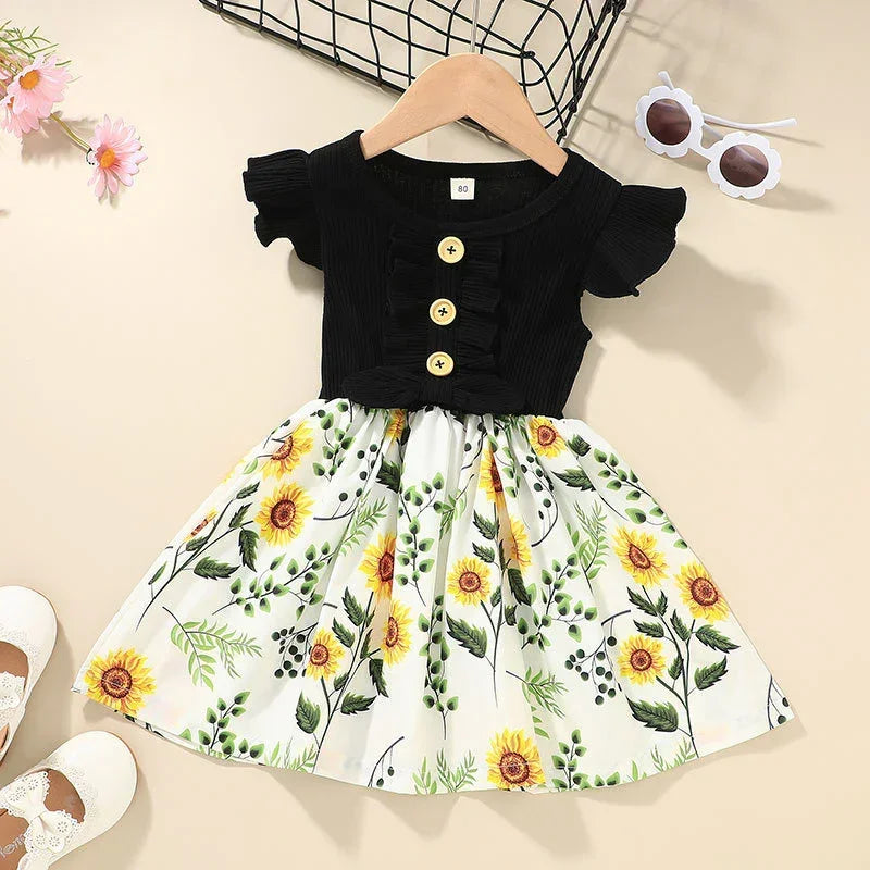 Girls' short sleeve dress with black ribbed top, button details, and sunflower print skirt