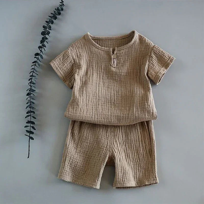 Beige textured cotton short-sleeve shirt and shorts set, relaxed fit, minimal design.