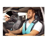 Man wearing a teal and black padded neck and shoulder massager vest with a car plug, relaxed fit.
