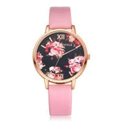 Floral-faced watch with a gold case and pink leather strap, feminine streetwear accessory