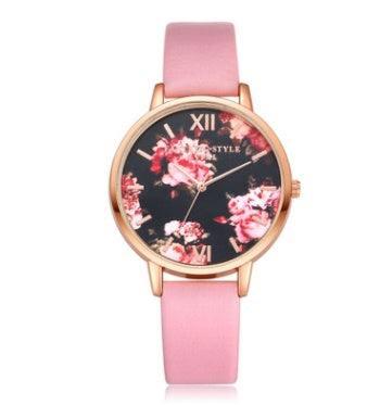 Floral-faced watch with a gold case and pink leather strap, feminine streetwear accessory