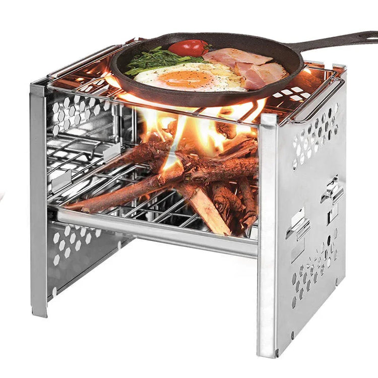 Portable stainless steel wood burning camping stove with grilled breakfast in a skillet