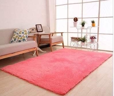 Modern living room with a large pink plush area rug on light wood flooring