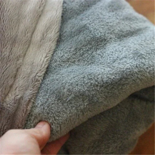 Close-up of soft, plush grey fleece fabric with neutral lining, showcasing cozy texture.