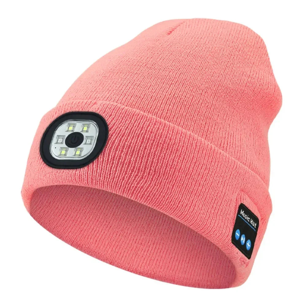 Pink knit beanie with built-in LED headlamp and Bluetooth panel, tech streetwear style
