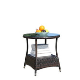 Round glass-top wicker side table with shelf, holding stacked books and a bowl of fruit