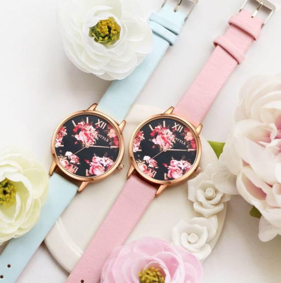 Floral face watches with pastel pink and blue leather straps, gold case, feminine style