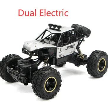 Black and silver remote control off-road truck with large rugged tires on white background