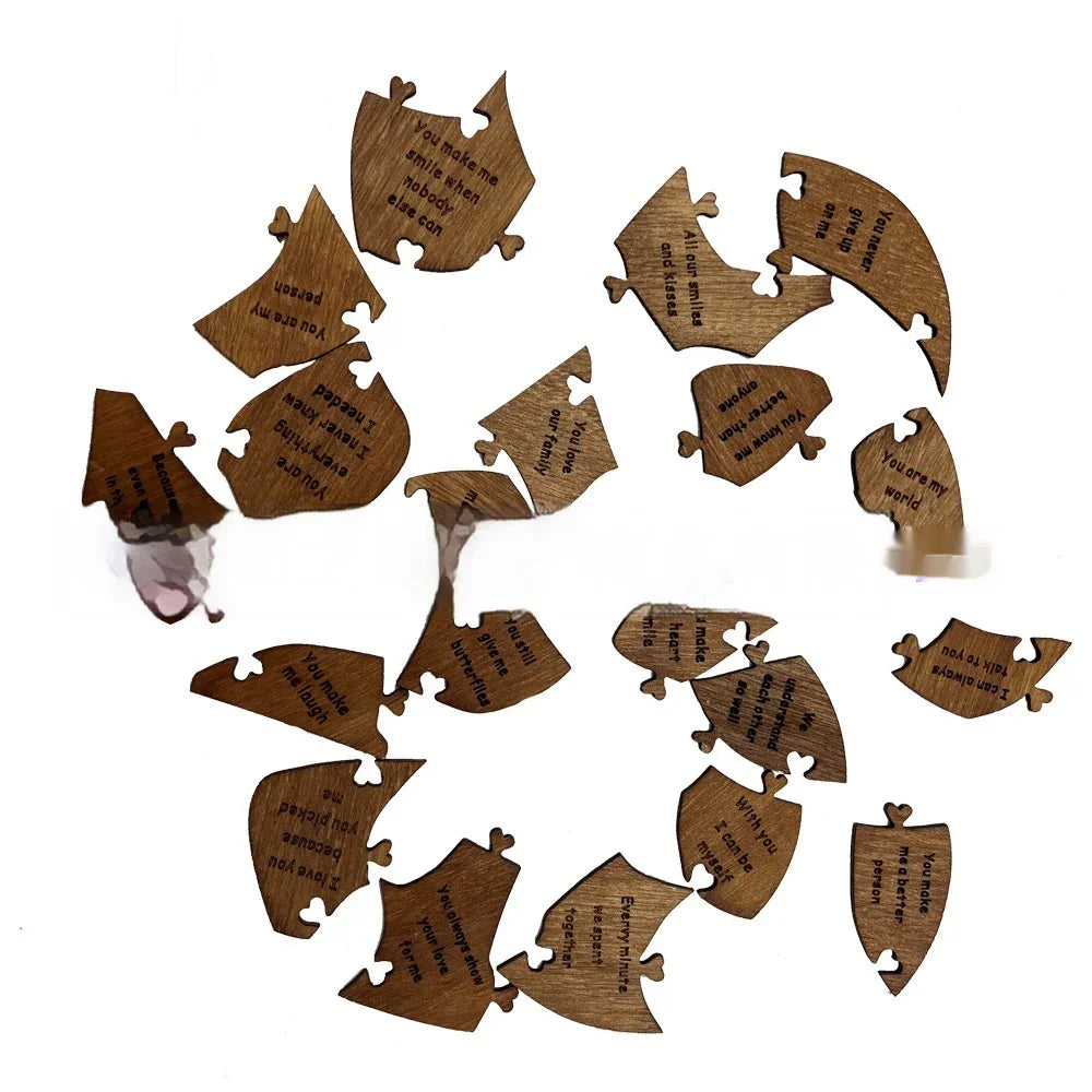 Scattered wooden puzzle pieces with engraved love messages on a white background.