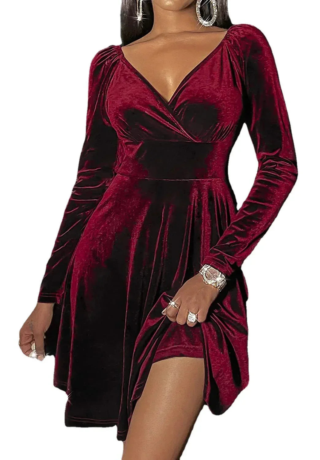 Woman wearing a burgundy velvet long sleeve mini dress with V-neck and fitted waist
