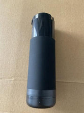 Matte black insulated tumbler with sleek cylindrical design on a brown background