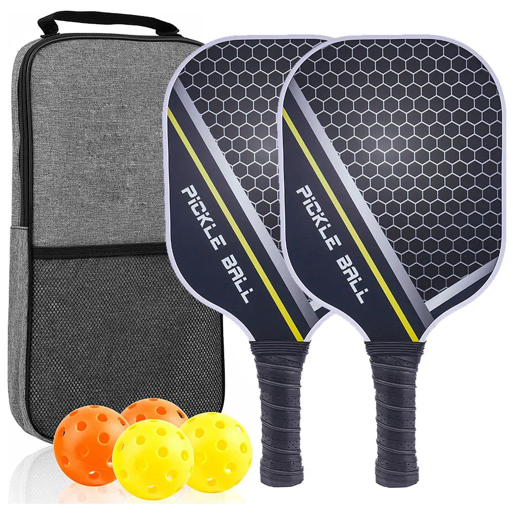 Two black honeycomb-pattern pickleball paddles with grip handles, four perforated balls, and a grey carrying case.