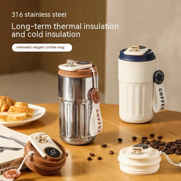 Stainless steel and ceramic insulated coffee mugs with digital temperature display, minimalist style.