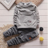 Light grey long-sleeve sweatshirt and dark grey jogger pants set, soft cotton, relaxed fit.
