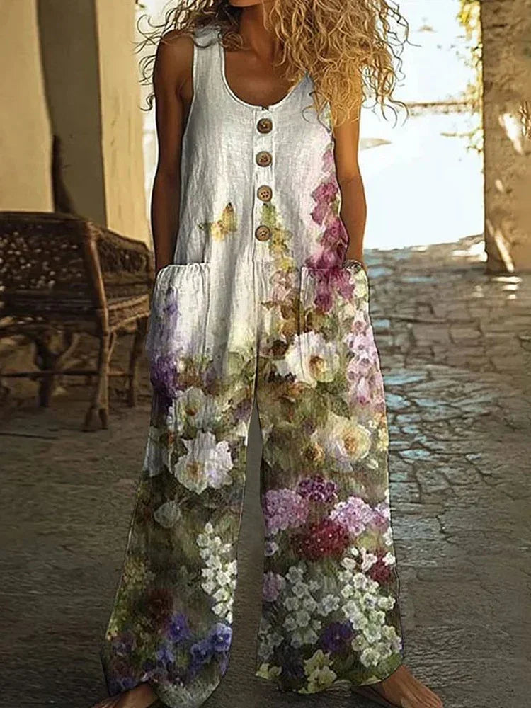 Sleeveless wide-leg floral jumpsuit with button front, loose fit, and large pockets.