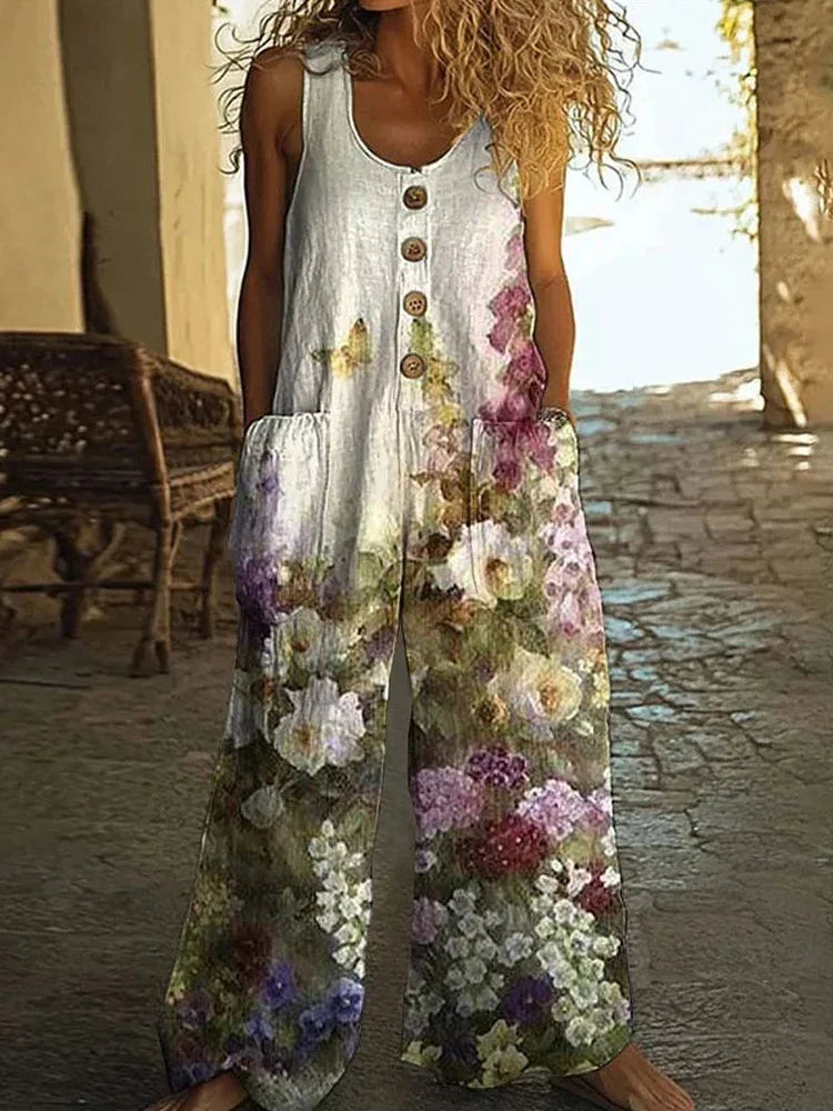 Sleeveless wide-leg floral jumpsuit with button front, loose fit, and large pockets.
