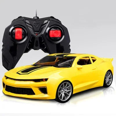 Yellow remote control car with black racing stripes and black controller in background