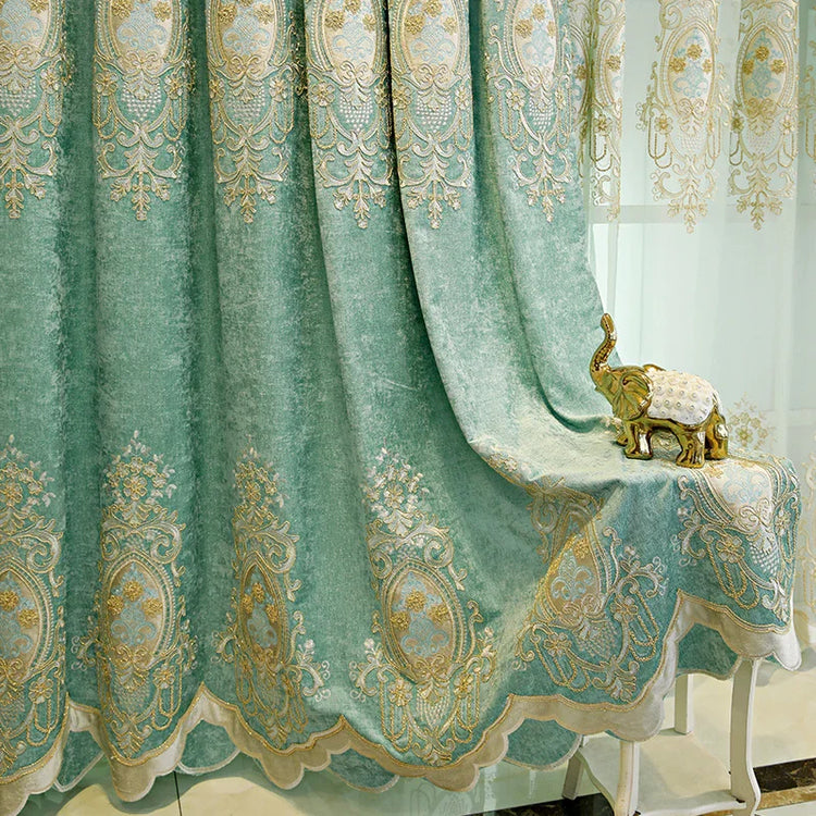 Light teal velvet curtain with gold embroidered patterns and scalloped edge, draped beside a gold decorative elephant figurine.