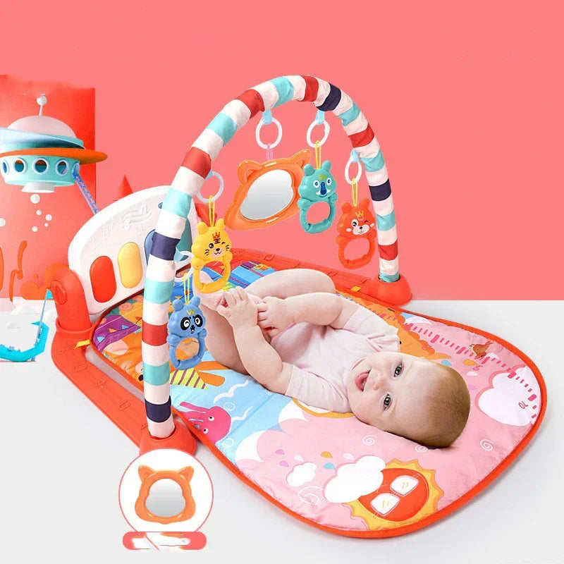 Baby lying on colorful soft play mat with hanging animal toys, short-sleeve bodysuit