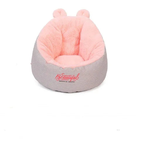 Soft pink and gray plush chair with bear ears, cozy faux fur material, rounded fit.