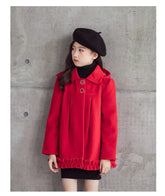 Girl wearing a red wool coat with ruffled hem, black knit dress, and black beret, modern fit