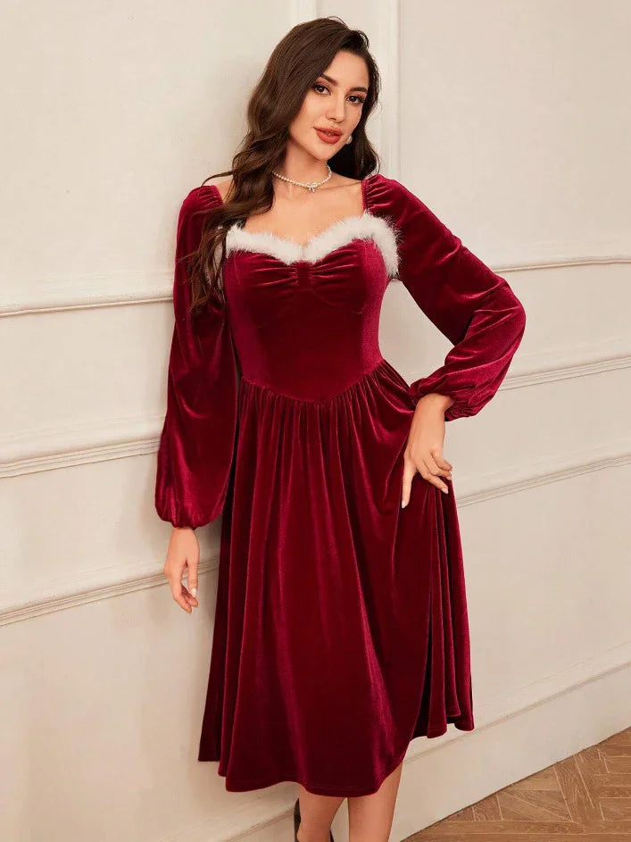 Woman wearing a velvet red midi dress with long sleeves and white faux fur trim, relaxed fit