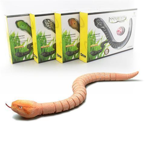 Realistic orange and beige remote control snake toy with segmented body, displayed with boxed packaging.