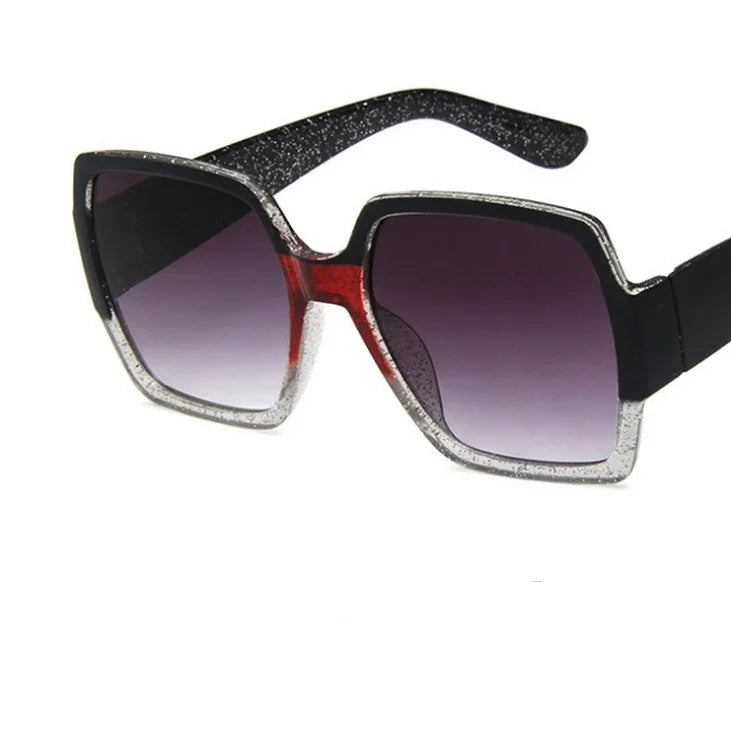 Square oversized sunglasses with black, silver glitter, and red accents, gradient lenses