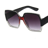 Square oversized sunglasses with black, silver glitter, and red accents, gradient lenses