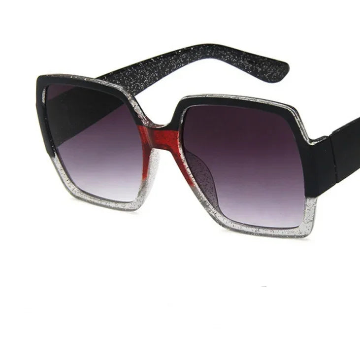 Square oversized sunglasses with black, silver glitter, and red accents, gradient lenses