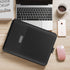 Sleek black leather laptop sleeve on a wooden desk with laptop, smartphone, and coffee cup