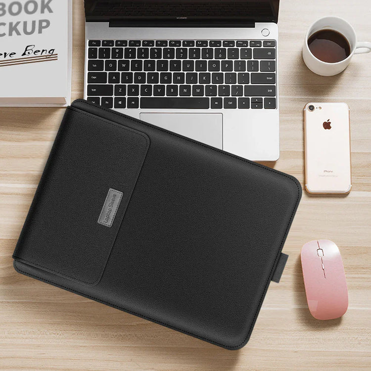 Sleek black leather laptop sleeve on a wooden desk with laptop, smartphone, and coffee cup