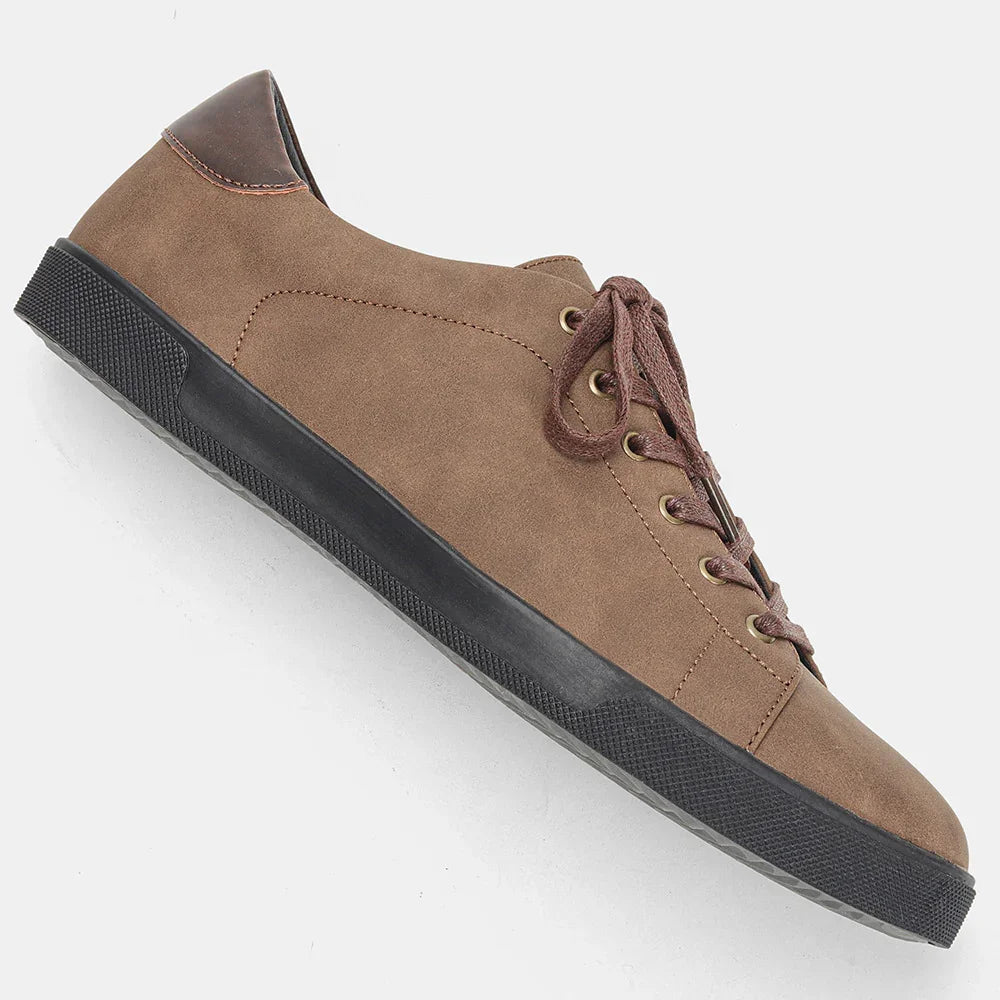 Brown suede low top sneaker with black rubber sole and lace-up closure, casual streetwear style